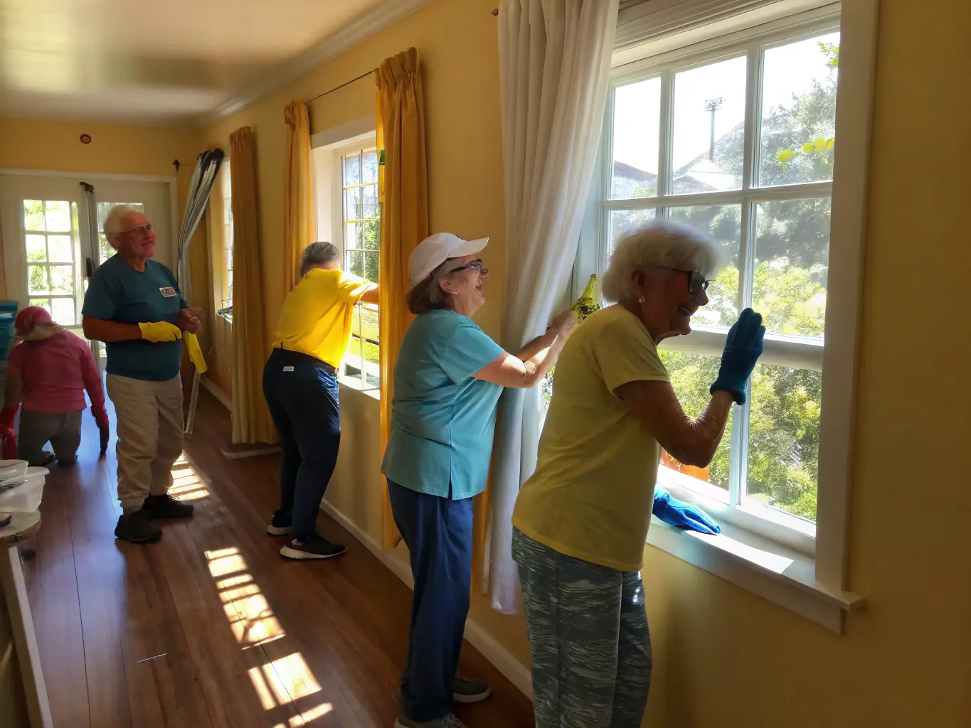A heartwarming image showing volunteers assisting elderly community members with daily tasks, highlighting SOLIDARITE ET DEVELOPPEMENT's dedication to social support and inclusion.
